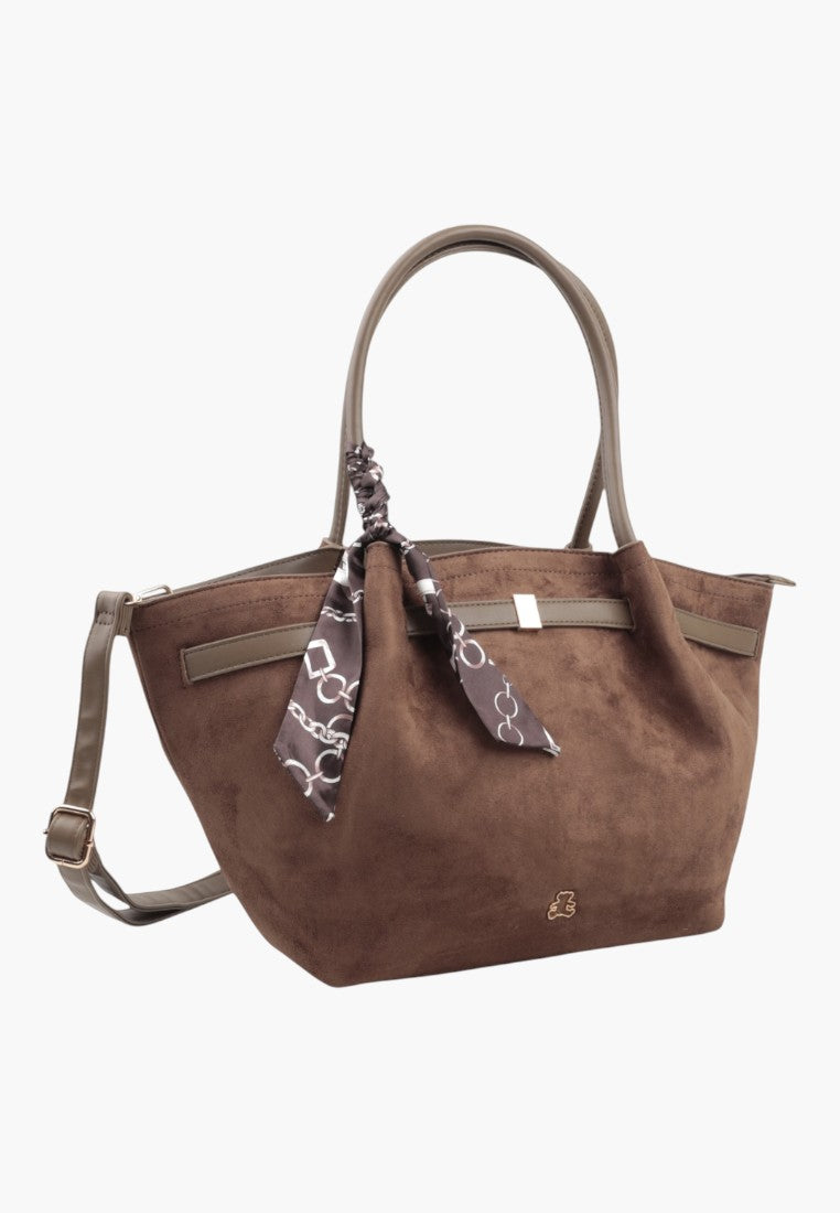 Front view of the taupe faux suede shopper bag with decorative scarf and shoulder strap.