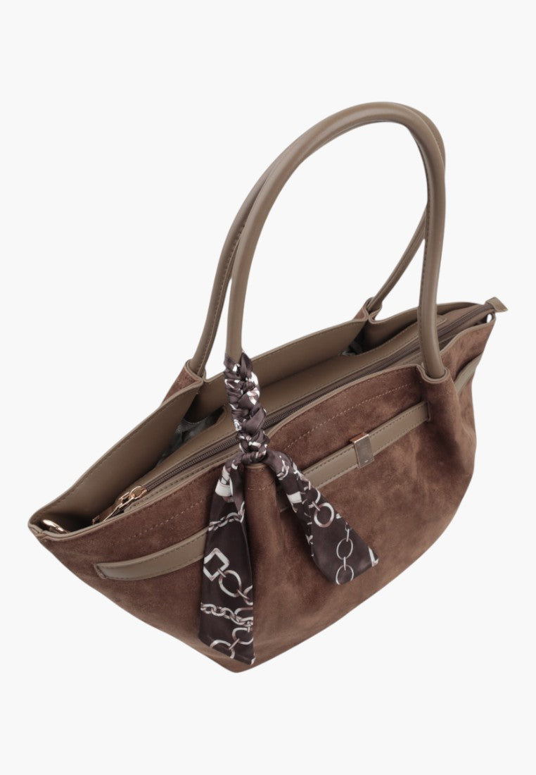 Side view of the taupe faux suede shopper bag with tassel details and zipper closure.