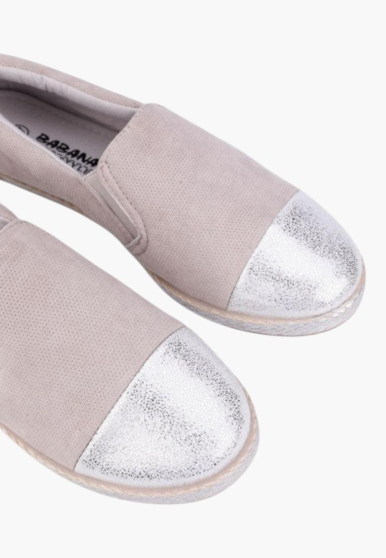 Side view of beige slip-on shoes showcasing the slip-on design.