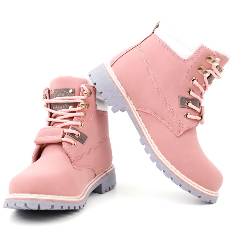 Other view of pink lace-up boots with a chunky sole on a white background.