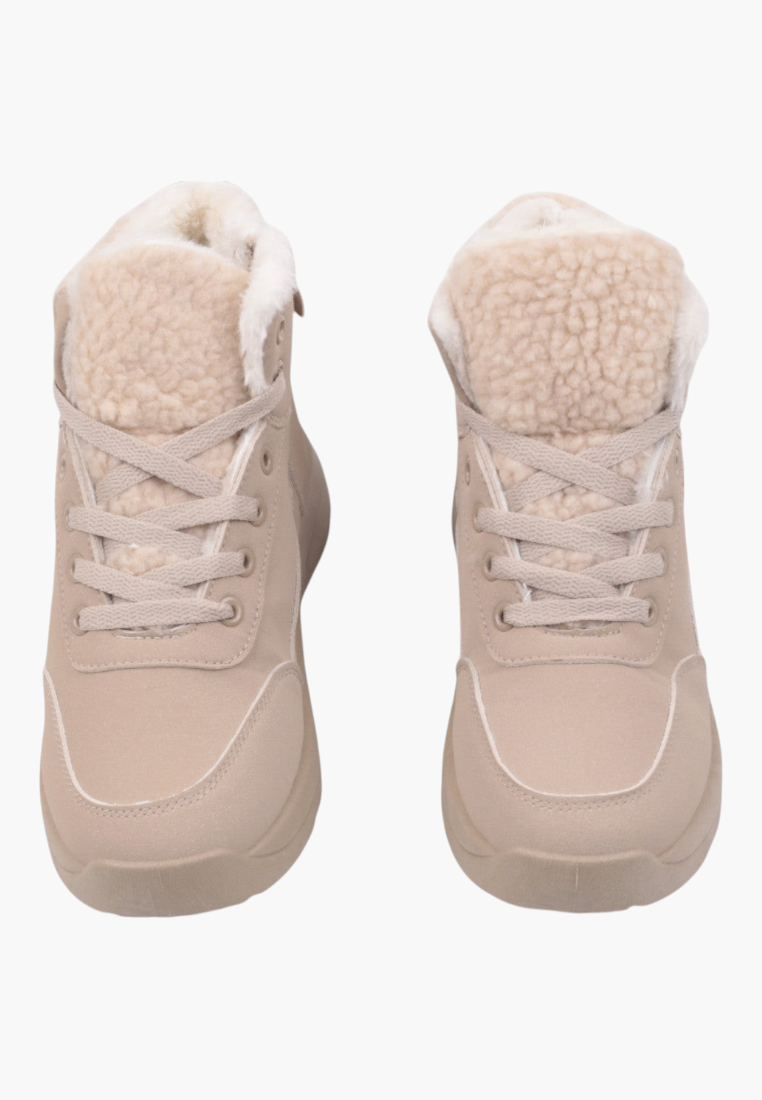 Detail close-up of beige winter boots highlighting fur lining and rounded toe.
