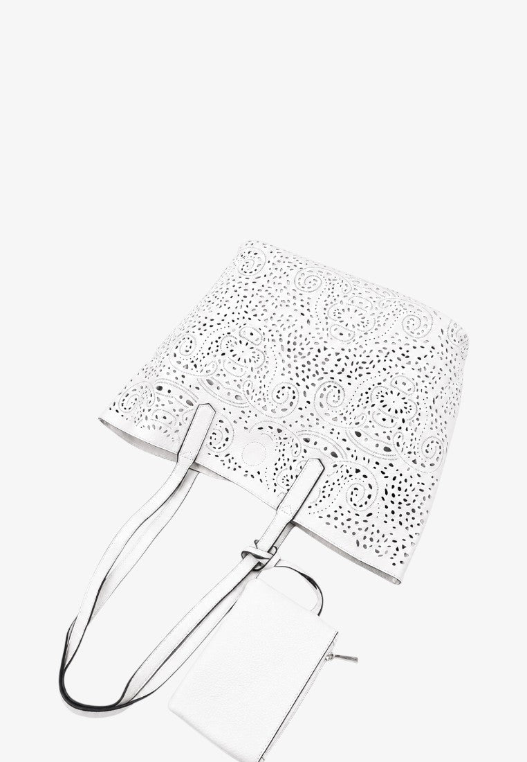 Detail top view of a white patterned tote bag featuring a detachable tag.