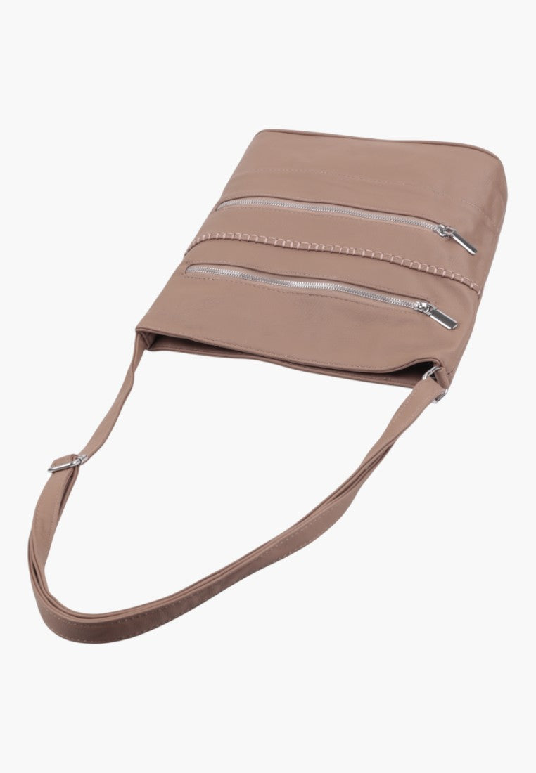 Close-up detail of a beige shoulder bag showcasing its unique shape and lightweight design.