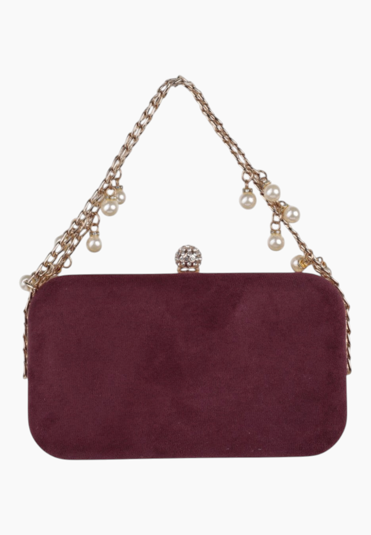 Back view of the burgundy clutch bag featuring a smooth surface and chain strap.