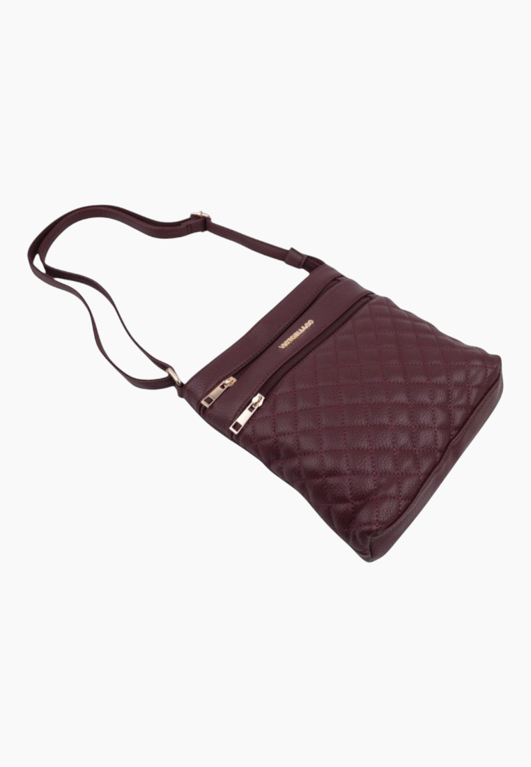 Side view of brown handbag with quilted design and adjustable strap